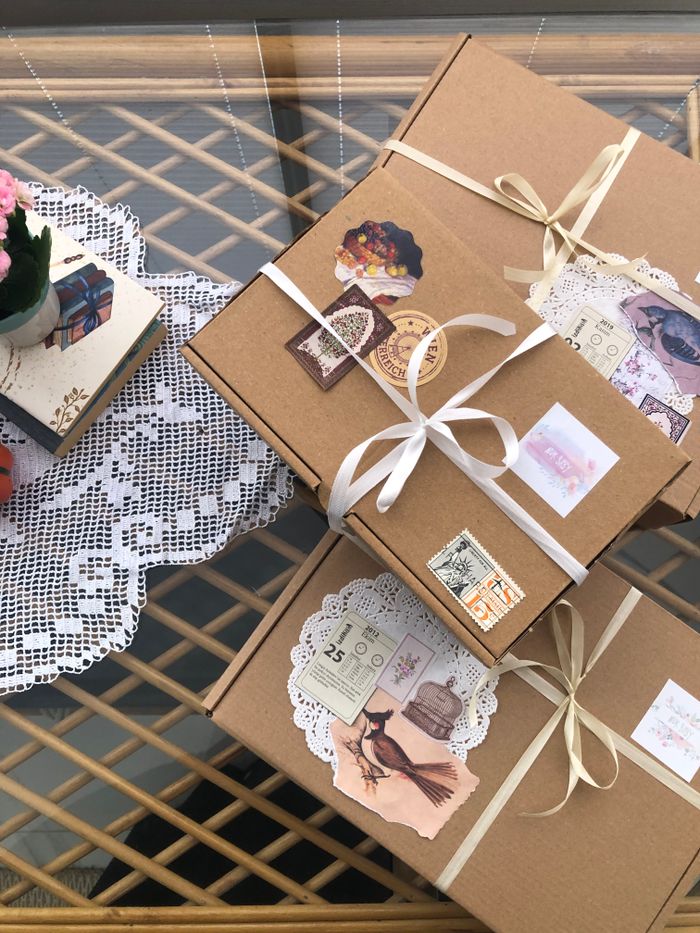 Charming gift boxes with vintage embellishments and lace on a decorative table.